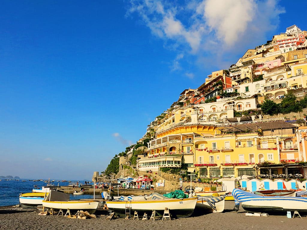 Amalfi Coast Positano, Italy, view of the boats and building, hotels on the side of the mountains, photo taken from the beach