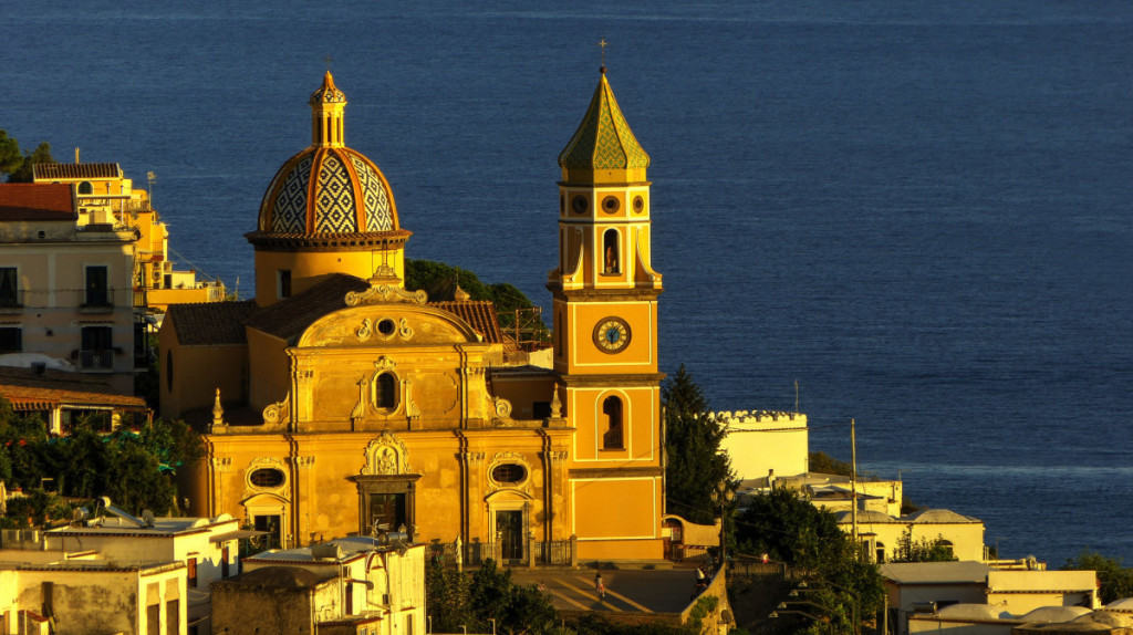 Praiano, Amalfi Coast, Italy, sunset view of the church, orange colour, water in background
