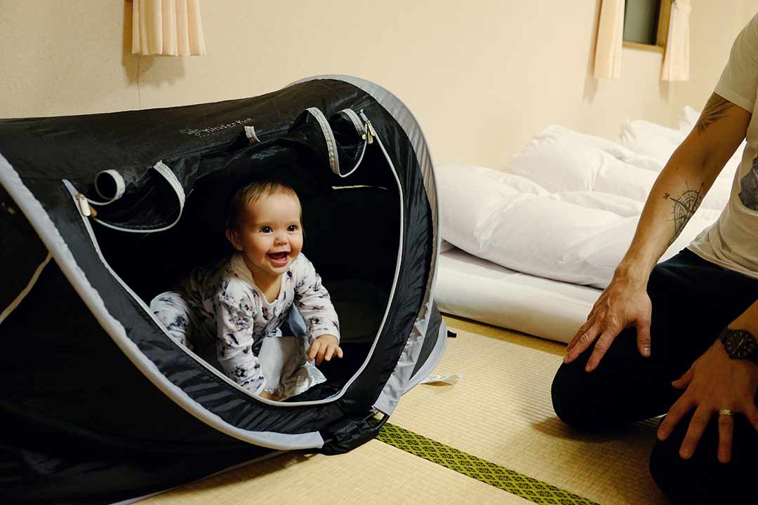 Best Travel Cot, baby in the travel cot, hotel room in Japan