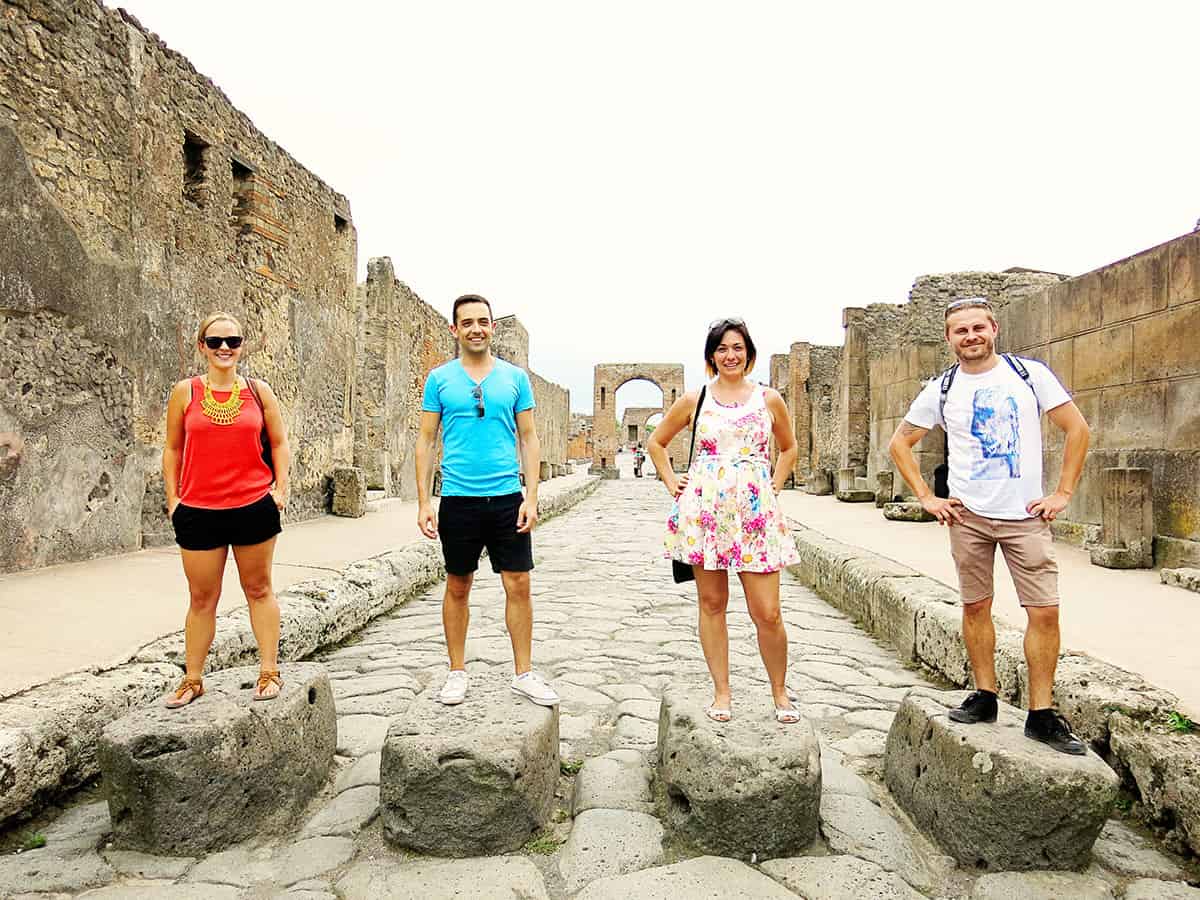 Pompeii, Italy, people standing on the rocks in the middle of the Pompei street, cobble stone