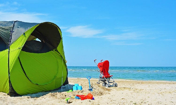 Baby Beach Tent at the beach, and a stroller, beach toys