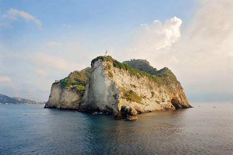 Beautiful island - Vivara in Italy, rocky island with a white lighthouse on the top