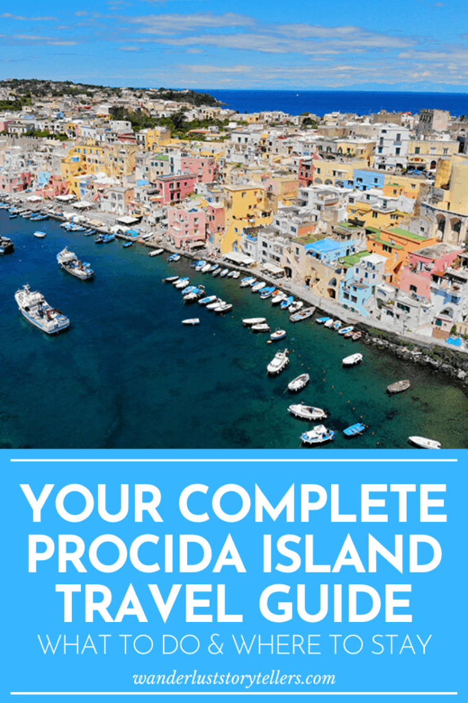 Your Complete Procida Island Travel Guide pinterest photo with writing, coastal town from the top, colourful buildings, fishing boats