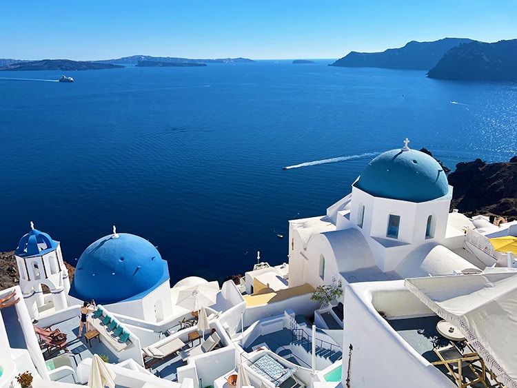 Santorini in September - view of the Oia from the top looking at the white buildings and blue domes