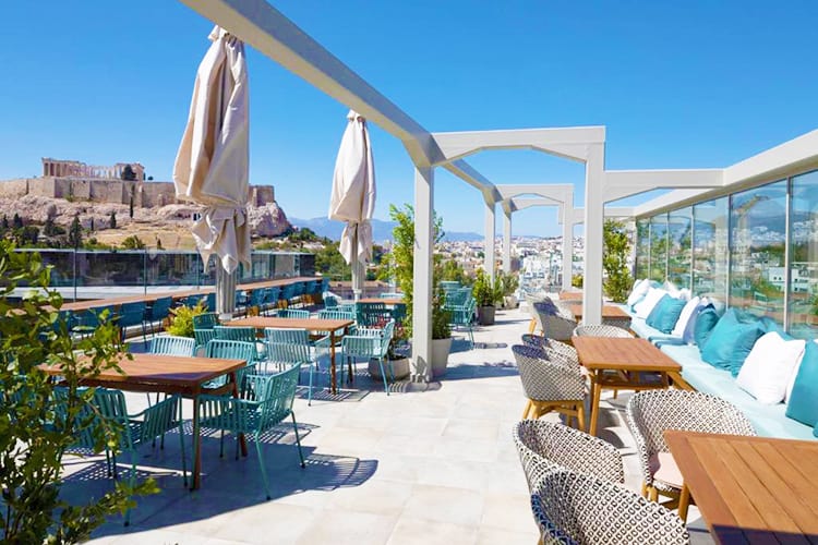 Coco-mat Athens hotels with rooftop pools, Greece, rooftop pool area, tables and chairs