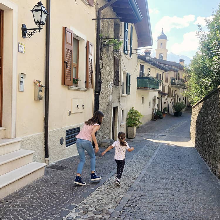 Two girls playing in the streets of Limone Sul Garda - Lake Garda Italy